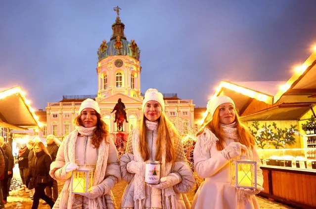 Women from Ukraine dressed up as angels pose as they collect donations for Ukrainian children at the Christmas market in front of Charlottenburg Palace in Berlin, Germany on November 24, 2022. (Photo by Lisi Niesner/Reuters)