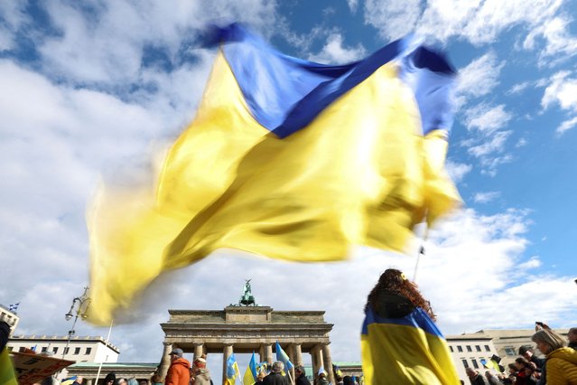 A person waves a Ukrainian flag, as protesters gather for a demonstration “#VictoryForPeace FRIEDEN VERTEIDIGEN”, marking the second anniversary of the Russian invasion of Ukraine in Berlin, Germany, on February 24, 2024. (Photo by Lisi Niesner/Reuters)