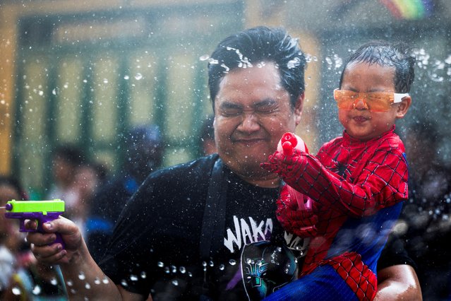 Revellers play with water as they celebrate the Songkran holiday which marks the Thai New Year in Bangkok, Thailand, on April 14, 2024. (Photo by Chalinee Thirasupa/Reuters)