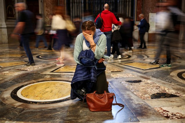 A woman reacts as Pope Francis lies in state in St. Peter's Basilica, at the Vatican, on April 25, 2025. (Photo by Carlos Barria/Reuters)