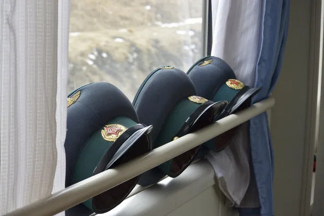 Military hats rest next to the window on the train from the capital back to Beijing in February 2013, in Pyongyang, North Korea. (Photo by Andrew Macleod/Barcroft Media)