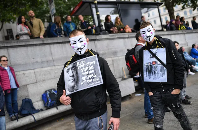 Two men wearing masks are seen at the Unite for Freedom protest in Trafalgar Sq on August 29, 2020 in London, England. Speakers, including Jeremy Corbyn's brother Piers Corbyn, spoke to hundreds of people gathered in Trafalgar square during an anti-mask demo. (Photo by Peter Summers/Getty Images)