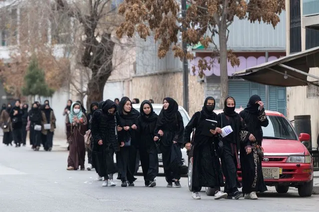 Afghan high schoolgirls return from school after taking part in their high school graduation exam in Kabul on December 7, 2022. (Photo by Wakil Kohsar/AFP Photo)