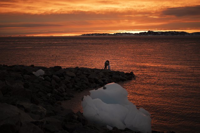 Ana, 18, and Victor, 19, embrace as they watch the sunset in Nuuk, Greenland, Sunday, February 16, 2025. (Photo by Emilio Morenatti/AP Photo)