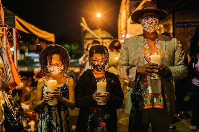 A family stand with candles during a candlelight vigil on August 30, 2020 in Minneapolis, Minnesota. The community gathered in the intersection of 38th Street and Chicago Ave for a candlelight vigil to honor Jacob Blake, 29, who was shot on August 23. Video filmed of the incident appears to show Blake shot multiple times in the back by Wisconsin police officers while attempting to enter the drivers side of a vehicle. The 29-year-old Blake was undergoing surgery for a severed spinal cord, shattered vertebrae and severe damage to organs, according to the family attorneys in published accounts. (Photo by Brandon Bell/Getty Images)