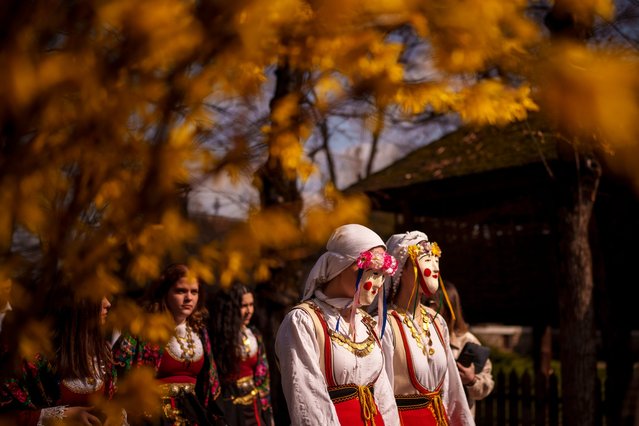 People wearing masks and costumes take part in a parade at the Village Museum in Bucharest, Romania, Saturday, March 16, 2024, marking the upcoming Clean Monday, the beginning of the Great Lent, 40 days ahead of Orthodox Easter. (Photo by Andreea Alexandru/AP Photo)