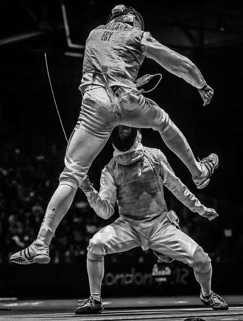 The 2nd prize Sports – Sports Action Stories by Sergei Ilnitsky, Russia, for European Pressphoto Agency, shows Alaaeldin Abouelkassem of Egypt (top) in action against Peter Joppich of Germany (C) during their Men's Foil Individual Round16 match for the London 2012 Olympic Games in London, Britain, July 31, 2012. (Photo by Sergei Ilnitsky/European Pressphoto Agency)