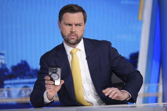 Vice President JD Vance checks his phone just before his interview with Bret Baier on FOX News Channel’s Special Report with Bret Baier at the FOX News bureau in Washington, Monday, June 23, 2025. (Photo by J. Scott Applewhite/AP Photo)