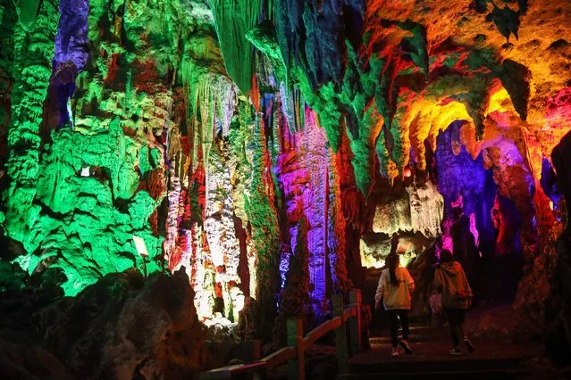 This photo taken on January 10, 2023 shows tourists visiting Yinziyan cave in Lipu county, Guilin city, in China's southern Guangxi region. (Photo by AFP Photo/China Stringer Network)