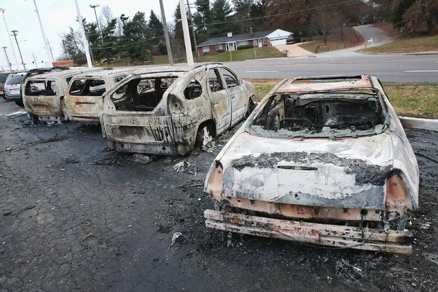 Cars which were set on fire when rioting erupted following the grand jury announcement in the Michael Brown case sit on a lot on November 25, 2014 in Dellword Missouri. Brown, an 18-year-old black man, was killed by Darren Wilson, a white Ferguson police officer, on August 9. At least 12 buildings were torched and more than 50 people were arrested during the night-long rioting. (Photo by Scott Olson/Getty Images)