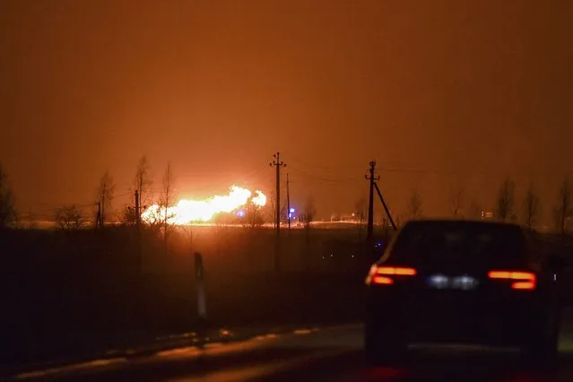 A flame rises after an explosion at a gas pipeline near Pasvalys, 175 km (109 miles) north of Vilnius in northern Lithuania on Friday, January 13, 2023. Officials say an explosion has occurred in a pipeline in central Lithuania carrying natural gas to the north of the country and neighboring Latvia but no supply disruptions or injuries were reported. Baltic media reported that Friday's blast sent flames up to 50 meters (164 feet) into the sky and forced the protective evacuation of a nearby village. (Photo by Paulius Zidonis/AP Photo)