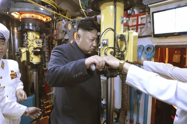 North Korean leader Kim Jong Un (C) looks through a periscope of a submarine during his inspection of the Korean People's Army (KPA) Naval Unit 167, in this undated file photo released by North Korea's Korean Central News Agency (KCNA) in Pyongyang on June 16, 2014. (Photo by Reuters/KCNA)