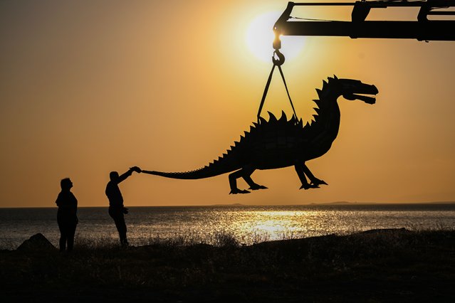 Iranian sculptor Ali Mutii, living in Van, transformed iron collected from scrap dealers into a sculpture of the “Van Lake Monster” in Van, Turkiye, on July 08, 2025. The sculpture, completed after long efforts and weighing 600 kilograms, was brought to the shore of Van Lake by crane, as it surprises those who saw it. (Photo by Ozkan Bilgin/Anadolu via Getty Images)