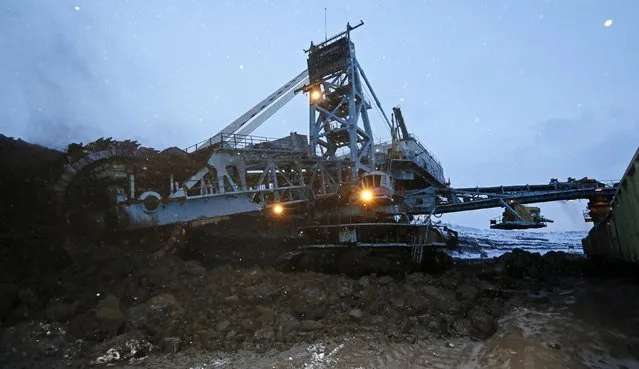 A rotary dredge works on the coal face of the Borodinsky opencast colliery, near the Siberian town of Borodino, east of Krasnoyarsk, December 9, 2014. (Photo by Ilya Naymushin/Reuters)