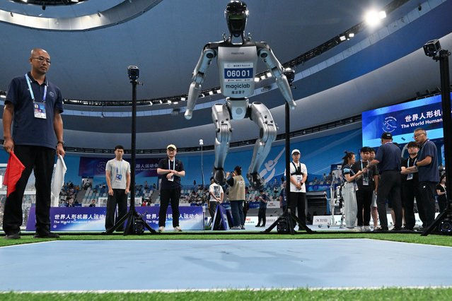 A robot competes in the high jump category during the World Humanoid Robots Games in Beijing on August 16, 2025. (Photo by Adek Berry/AFP Photo)