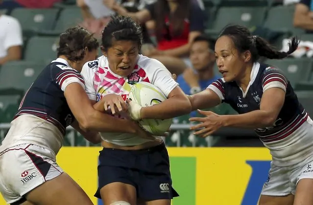 Japan's Takeuchi Aya (C) is tackled by Hong Kong's Christy Cheng Ka Chi (R) during their Asia rugby's sevens women qualifying tournament for the 2016 Rio Olympics, in Hong Kong, China November 7, 2015. (Photo by Tyrone Siu/Reuters)