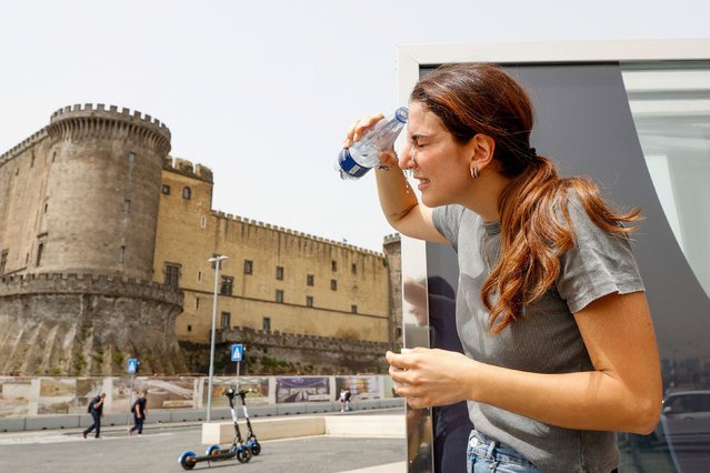 Woman cools off with water during a heatwave in Naples, Italy, on June 21, 2024. (Photo by Ciro De Luca/Reuters)