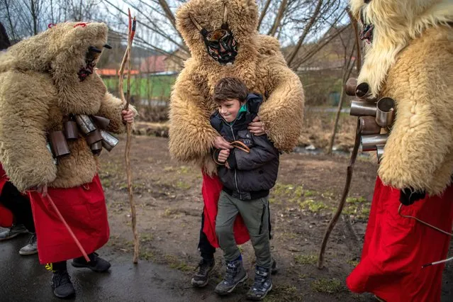 Participants dressed in traditional costumes walk from house to house during the seasonal St. Nicholas parade in village of Valasska Polanka, near Vsetin, Czech Republic, 05 December 2020 (issued 06 December 2020). Local men costumed as devils, grim reapers, and St. Nicholas walk from house to house during the annual St. Nicholas parades which are popular in a few villages in the Wallachia region, an eastern part of the Czech Republic near the Slovak border and was affected by coronavirus pandemic this year. Companies had to wait for level 3 of the Czech Anti-epidemic system and these parades were allowed in compliance with the measures. St. Nicholas and his devilish company roam the streets giving sweets and tiny gifts as a present to children. Devils often chase young. The local population is joining this ages-old tradition for many generations. The masks are produced by the locals themselves and are handed over from generation to generation and vary in each village. (Photo by Martin Divísek/EPA/EFE)