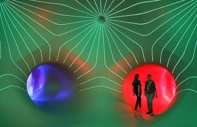 Visitors look around inside one of the rooms during a preview of the LuminiMax installation by Architects of Air set up on the front lawn of the Owensboro Convention Center, Thursday, October 2, 2025, in Owensboro, Ky. LuminiMax is just just one of the 13 exhibits that will be spread across downtown starting Friday evening for the city's “Illuminate: An Art and Light Experience”.  Photo by (Alan Warren/The Messenger-Inquirer via AP Photo)