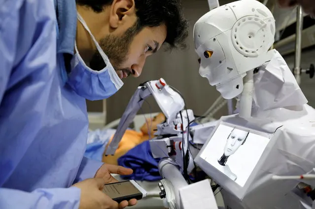 Mahmoud El Komy, a 26-year-old Egyptian mechatronics engineer, stands beside Cira 3, a remote-controlled robot that runs tests on suspected coronavirus disease (COVID-19) patients, to limit the human exposure to the virus, amid a second wave of infections in Tanta, Egypt, November 18, 2020. (Photo by Mohamed Abd El Ghany/Reuters)