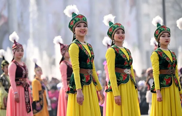 Women wearing traditional costumes take part in the Nooruz celebrations at Ala-Too square in Bishkek, Kyrgyzstan, 21 March 2023. Nooruz, also called Nowruz, marks the first day of spring and is usually celebrated on 21 March every year, on the day of the astronomical vernal equinox. (Photo by Igor Kovalenko/EPA)