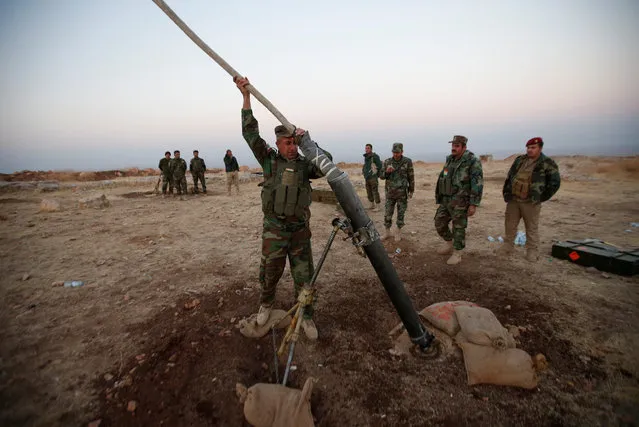 Peshmerga forces prepare to launch a mortar during an operation to attack Islamic State militants in the town of Naweran near Mosul, October 23, 2016. (Photo by Azad Lashkari/Reuters)