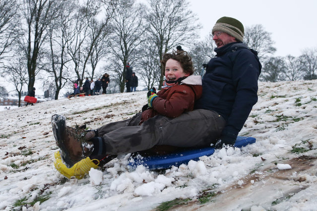 A father and son ride a sledge at Swan Pool Park, on December 28, 2020 in Stourbridge, England. Heavy snow fall has covered the West Midlands as the Met Office has issued yellow warnings throughout the day. (Photo by Cameron Smith/Getty Images)