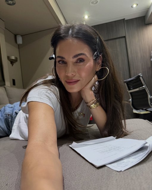 American actress and dancer Jenna Dewan on November 5, 2025 lounges in her film trailer while reviewing her script. (Photo by jennadewan/Instagram)