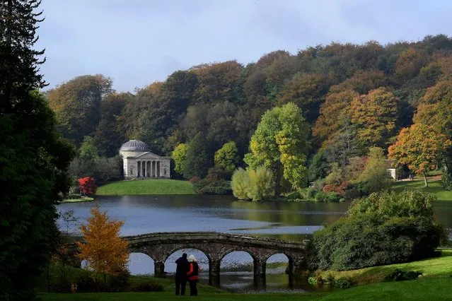 Visitors view the autumn foliage and colours in the gardens and estate at Stourhead in south west Britain, October 21, 2016. (Photo by Toby Melville/Reuters)