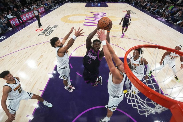 Minnesota Timberwolves guard Anthony Edwards (5) shoots as Denver Nuggets guard Jamal Murray, left, and Nikola Jokic, right, defend during the second half of an NBA basketball game, Saturday, November 15, 2025, in Minneapolis. (Photo by Abbie Parr/AP Photo)