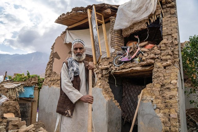 An Afghan man stands in front of his damaged house, in the aftermath of an earthquake at a village in the Khulm district of Samangan province on November 4, 2025. An earthquake of 6.3-magnitude in northern Afghanistan has killed at least 27 people and injured nearly 1,000, the health ministry said on November 4, announcing the end of rescue operations. (Photo by AFP Photo/Stringer)