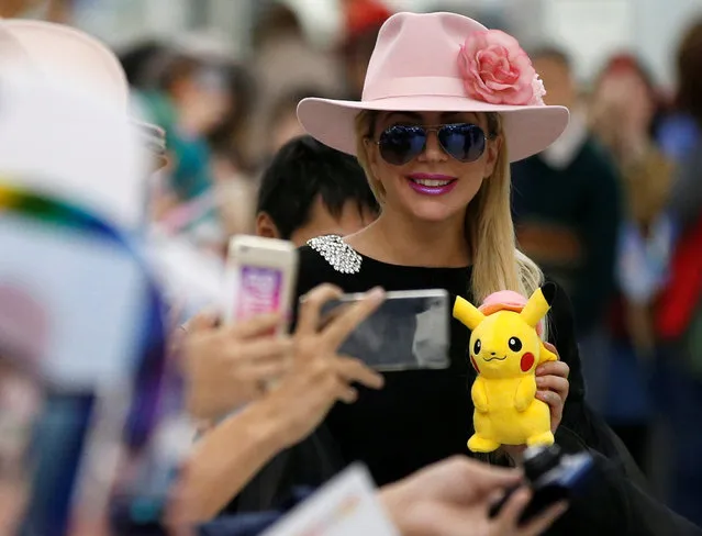 Singer Lady Gaga holds a Pokemon's “Pikachu” stuffed toy upon her arrival at Narita International airport in Narita, Japan, November 1, 2016. (Photo by Toru Hanai/Reuters)