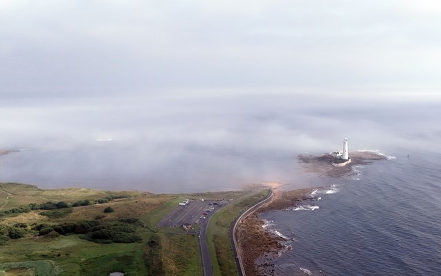 Mist surrounds St Mary's Lighthouse in Whitley Bay, North Tyneside on Sunday, July 20, 2025. Yellow weather warnings are in place for parts of the UK with thunderstorms threatening to bring flooding and disruption for the remainder of the weekend. (Photo by Owen Humphreys/PA Images via Getty Images)