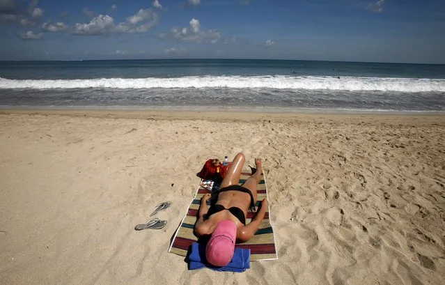 A tourist sunbathes at Kuta beach on Indonesia's resort island of Bali in this June 5, 2008 file photo. Indonesia is expected to release tourist arrival numbers for October this week. (Photo by Murdani Usman/Reuters)