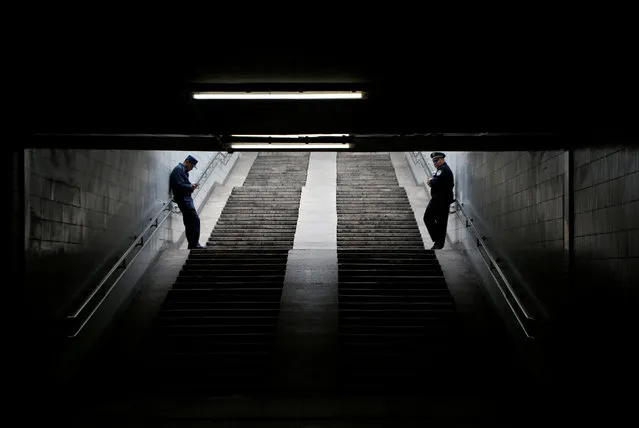 A policeman (R) and his assistant stand guard in an underground passage near Tiananmen Square on the first day of a plenary session of the 18th Central Committee of the Communist Party of China (CPC), in Beijing, China, October 24, 2016. (Photo by Jason Lee/Reuters)