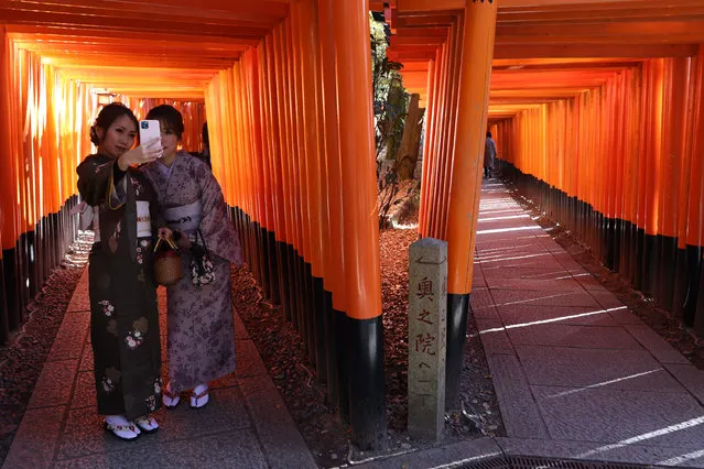 Women dressed in kimonos pose for a selfie photograph at a deserted torii path Fushimi Inari Taish shrine on January 18, 2021 in Kyoto, Japan. Kyoto, along with a Osaka and several other prefectures, was brought under a state of emergency last week by the Japanese government as they grapple to contain the third, and most virulent, wave of Covd-19 coronavirus to hit the country. (Photo by Buddhika Weerasinghe/Getty Images)