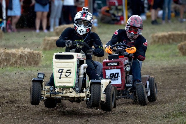 Drivers take part in an overnight lawn mower race at the Trooper Inn Field on August 10, 2024 in Petersfield, England. The 12-hour endurance race runs from 8 PM to 8 AM and see 45 teams compete on a 1.1km dirt track. According to the British Lawn Mower Racing Association, the sport was born in 1973 by an Irishman named Jim Gavin in West Sussex, who was having a few pints with his mates while watching a groundsman mow a cricket pitch. (Photo by Jack Taylor/Getty Images)