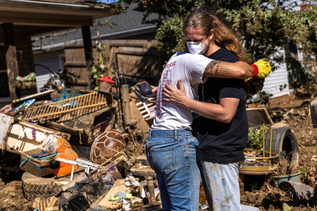 People react as volunteers help to clean their home covered in mud, following the passing of Hurricane Helene, in Swannanoa, North Carolina on October 7, 2024. Hurricane Helene came ashore in Florida's Big Bend region as a powerful Category 4 storm before turning its fury on much of the Southeast. Flash floods destroyed homes and ripped victims away from their families, killing at least 200 people across six states, making Helene the deadliest storm to hit the US mainland since Katrina. (Photo by Eduardo Munoz/Reuters)