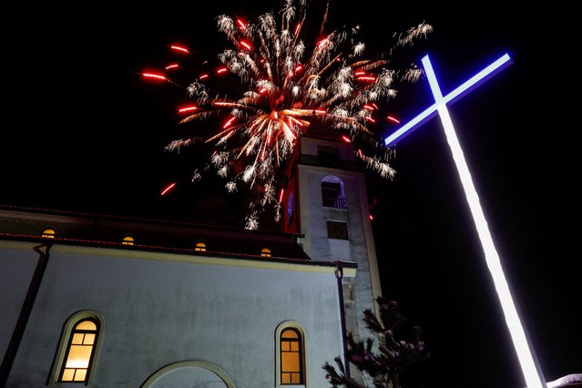 Fireworks illuminate the St. Nicholas church after the Christmas mass in the Croatian minority town, in Janjevo, Kosovo, on December 25, 2024. (Photo by Valdrin Xhemaj/Reuters)