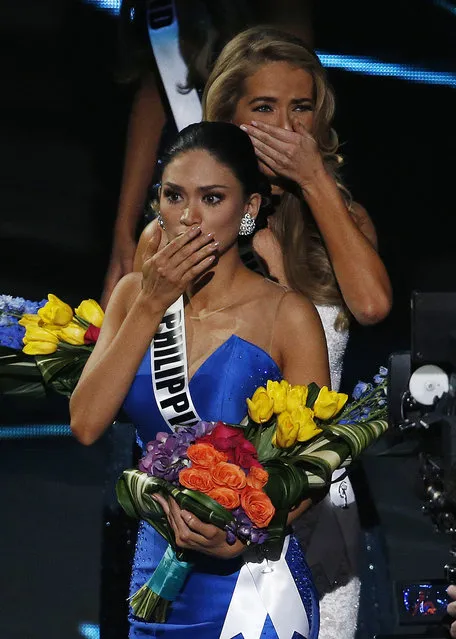 Miss Philippines Pia Alonzo Wurtzbach, front, reacts after she was announced as the new Miss Universe at the Miss Universe pageant on Sunday, December 20, 2015, in Las Vegas. Miss Colombia Ariadna Gutierrez was incorrectly named Miss Universe. In back is finalist Miss USA Olivia Jordan. (Photo by John Locher/AP Photo)