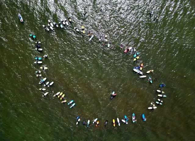 People participate in the Surfers Against Sewage protest next to Saltburn Beach in Saltburn, Britain on May 20, 2023. (Photo by Lee Smith/Reuters)