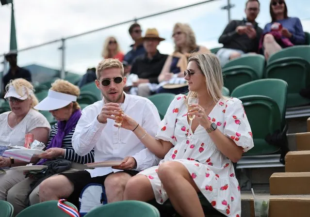 Spectators enjoy a drink at the Wimbledon Championships, Wimbledon, Britain, 03 July 2023. (Photo by Tolga Akmen/EPA)