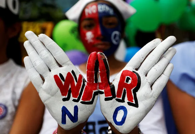 A girl with painted hands and face participates in a peace rally to commemorate the 73rd anniversary of the world's first atomic bombing in the Japanese city of Hiroshima during World War 2, in Mumbai, India, August 6, 2018. (Photo by Francis Mascarenhas/Reuters)