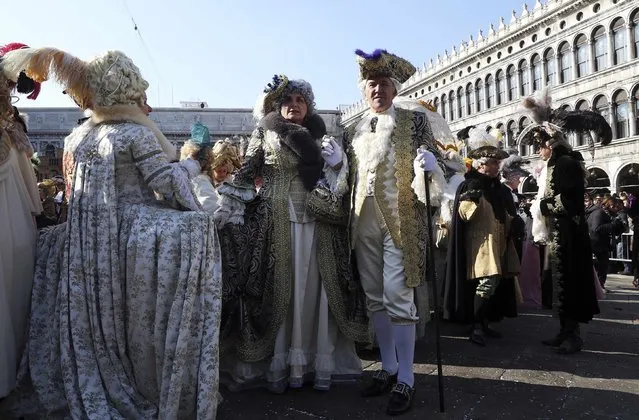 Revellers pose in Saint Mark square during carnival in Venice February 8, 2015. (Photo by Stefano Rellandini/Reuters)