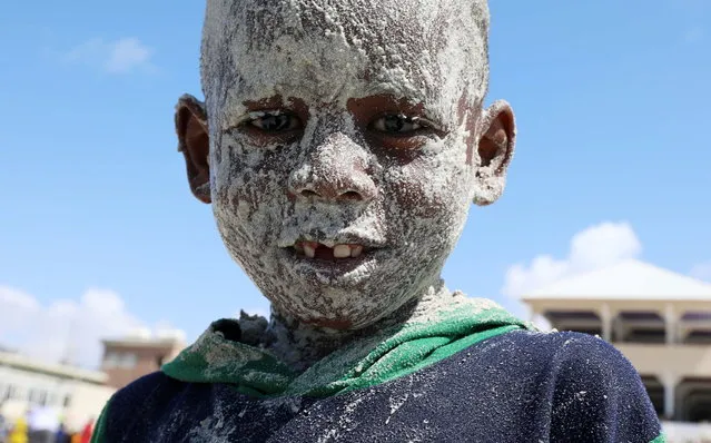 A Somali boy covers his face with sand at the Liido Beach during the last Friday ahead of the Muslim holy month of Ramadan, amid the coronavirus disease (COVID-19) pandemic in Mogadishu, Somalia on April 9, 2021. (Photo by Feisal Omar/Reuters)