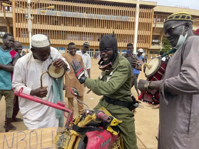 Supporters of Niger's ruling junta play instruments in Niamey, Niger, Sunday, August 6, 2023. Nigeriens are bracing for a possible military intervention as time's run out for its new junta leaders to reinstate the country's ousted president. (Photo by Sam Mednick/AP Photo)