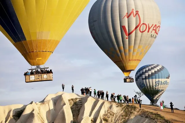 Tourists take part in hot air balloon rides on the first day of the Eid al-Fitr holiday in Cappadocia of Nevsehir, Turkiye on April 21, 2023. (Photo by Behcet Alkan/Anadolu Agency via Getty Images)