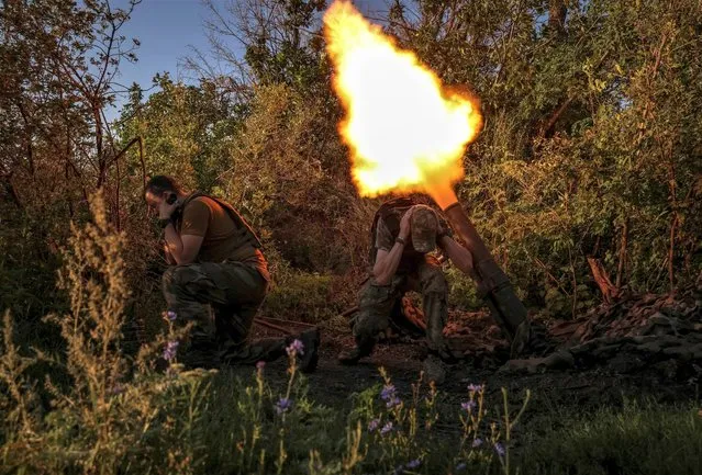 Ukrainian service members fire a mortar at their positions at a front line, amid Russia's attack on Ukraine, near the city of Bakhmut in Donetsk region, Ukraine on August 7, 2023. (Photo by Oleksandr Ratushniak/Reuters)