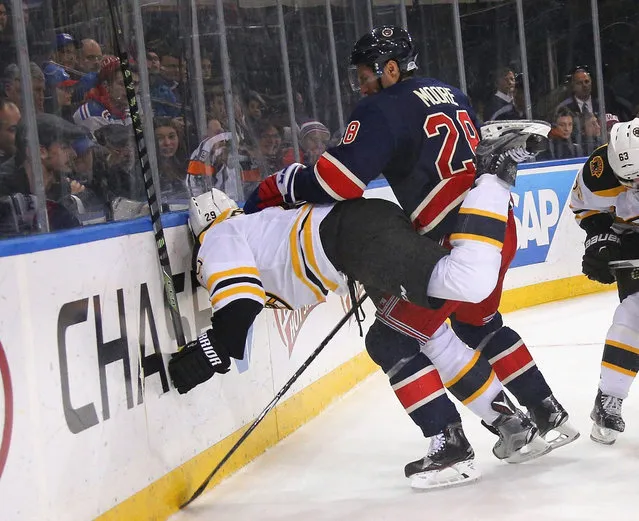 Dominic Moore #28 of the New York Rangers pushes Landon Ferraro #29 of the Boston Bruins into the boards during the third period at Madison Square Garden on January 11, 2016 in New York City. The Rangers defeated the Bruins 2-1. (Photo by Bruce Bennett/Getty Images)