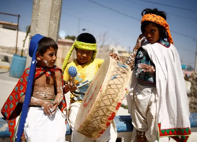 Indigenous Raramuri children participate in Good Friday celebrations in the Tarahumara neighborhood of Ciudad Juarez, Mexico on April 2, 2021. (Photo by Jose Luis Gonzalez/Reuters)